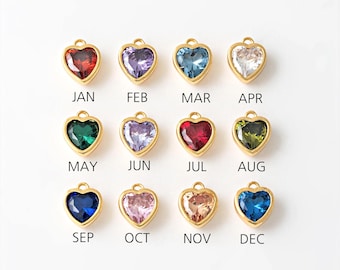 May include: Twelve gold heart-shaped charms with different colored crystals, representing each month of the year. January is red, February is purple, March is blue, April is white, May is green, June is light purple, July is red, August is green, September is blue, October is pink, November is light pink, and December is blue.