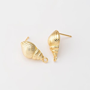 May include: A pair of gold-coloured seashell stud earrings. The earrings feature ridged textures and have a post and loop design. The earrings are set against a white background.