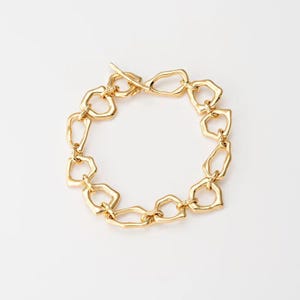 May include: A gold-toned bracelet with a chain made of interlocking, irregular, geometric shapes.