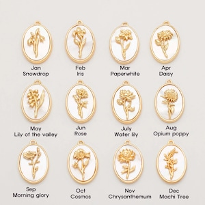 May include: Twelve gold oval charms with white enamel and floral designs. Each charm represents a different month of the year and features a different flower. The charms are arranged in four rows of three charms each.