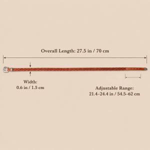 May include: A thin brown belt with a repeating diamond pattern, a silver-toned metal buckle, and a silver-toned tip. The belt has an overall length of 27.5 inches, a width of 0.6 inches, and an adjustable range of 21.4 to 24.4 inches.