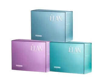 May include: Three rectangular boxes in shades of blue, teal, and purple are stacked. Each box has the word "ÉLAN" printed in white on the front. The boxes appear to be made of a metallic material.