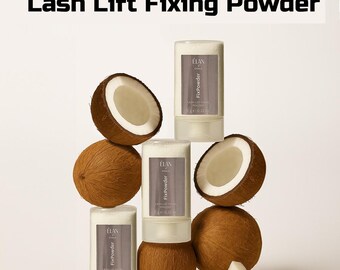 May include: An arrangement of coconuts and ELAN FixPowder Lash Lift Fixing Powder containers. The coconuts are brown with white interiors, and the powder containers are white with a gray label. The text "ELAN FixPowder Lash Lift Fixing Powder" is at the top.