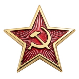 May include: A five-pointed star-shaped pin with a polished gold-tone metal border. The center features a deep red enamel background with a radiating sunburst pattern and a gold-tone hammer and sickle symbol embossed in the middle.