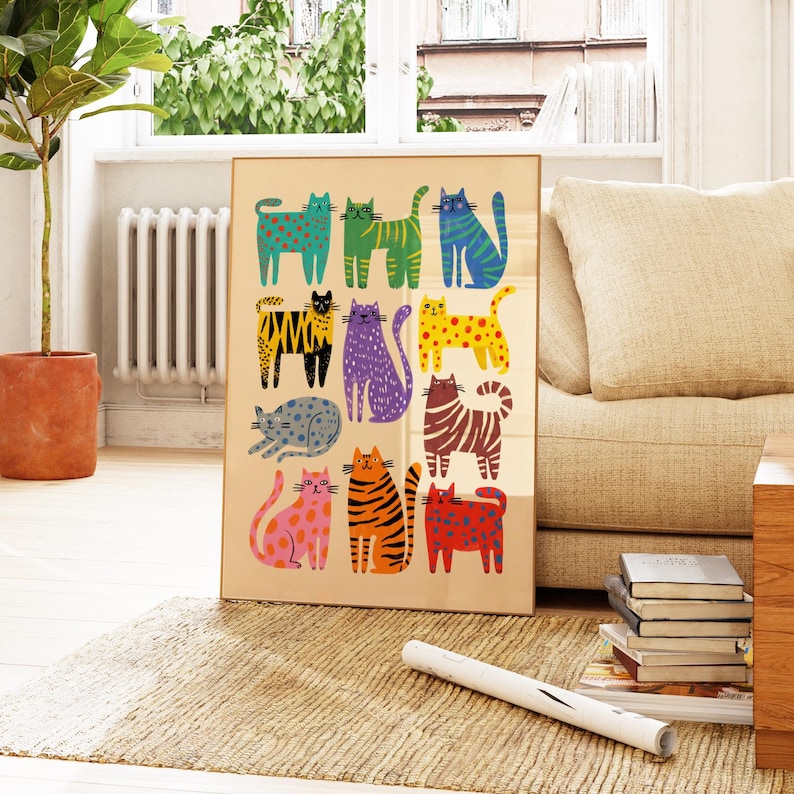 May include: A framed art print featuring a collection of stylized cats in various colors and patterns. The cats are arranged in rows on a beige background, with a gold frame. The artwork is displayed in a living room setting.