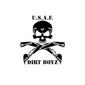 May include: Black and white sticker featuring a skull with crossed excavator arms. The text "U.S.A.F." is above the skull, and "DIRT BOYZ" is below. The design is a bold, graphic illustration.