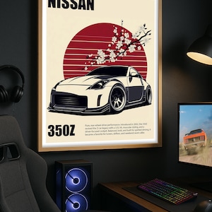 Puede incluir: Póster enmarcado con una ilustración de un coche Nissan 350Z blanco y negro. El diseño incluye un sol rojo, ramas de flores de cerezo y los textos "NISSAN" y "350Z". El póster se muestra en un entorno de oficina en casa.