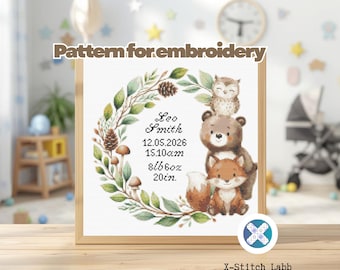 May include: A framed cross-stitch pattern for embroidery featuring a woodland theme. The design includes a wreath with leaves, pinecones, and mushrooms, surrounding the name "Leo Smith" and birth details. The design also includes a bear, fox, and owl.