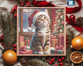 May include: A framed cross-stitch of a tabby cat wearing a Santa hat, surrounded by wrapped gifts and a Christmas tree. The image has a festive holiday theme, with red and green accents.