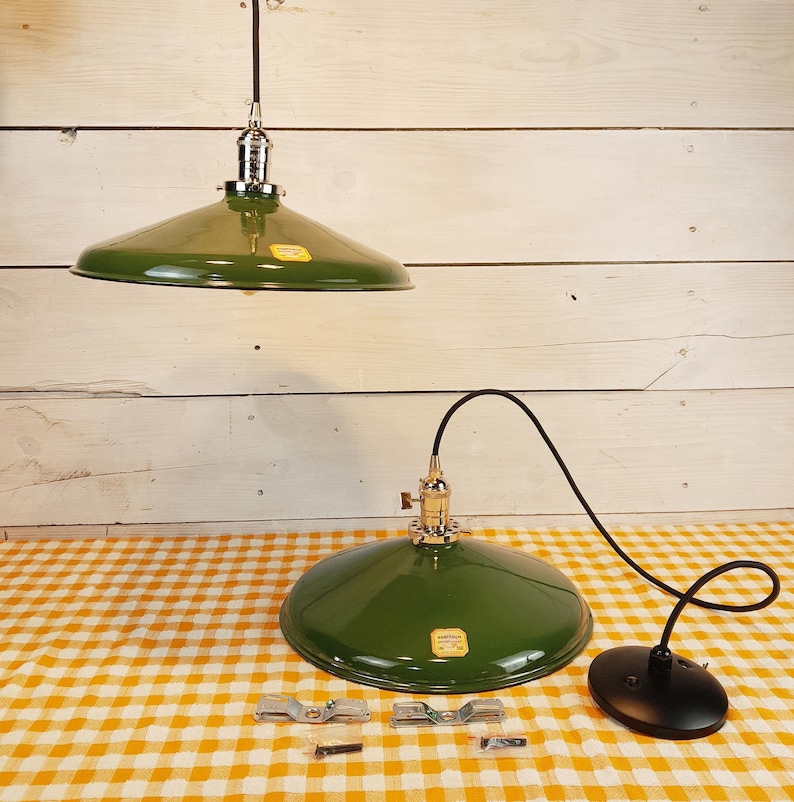 A pair of 14 inch green porcelain lights made in the USA by the Benjamin Electric Company. New Old Stock (NOS) in pristine condition with a modern polished nickle turnkey hanging on a 36" cord with a black canopy