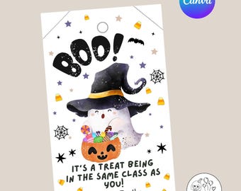 May include: A Halloween-themed gift tag featuring a ghost wearing a witch hat and holding a pumpkin basket filled with candy. The tag says "Boo!" and "It's a treat being in the same class as you!" with the name "Emily" at the bottom. The tag has a hole at the top.