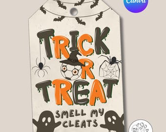 May include: A Halloween-themed gift tag with the words "Trick or Treat" in orange and black. The tag features a soccer ball, witch hat, spider, and ghost graphics. Text on the tag reads "Smell My Cleats" and "From: Emily".