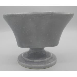 May include: A gray ceramic pedestal bowl with a flared rim and a round base. The bowl has a speckled texture and a smooth, glossy finish. The design is simple and elegant, suitable for various decorative purposes.