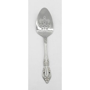 May include: A silver-colored serving spoon with a decorative floral design on the handle and a slotted, oval-shaped head. The head features a cut-out pattern. The spoon is designed for serving food.