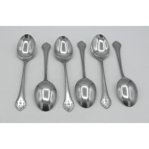 May include: A set of six silver-toned metal spoons arranged in two rows. Three spoons are positioned with the bowl facing upward, while the other three are placed with the bowl facing downward. Each handle features a decorative floral engraving.