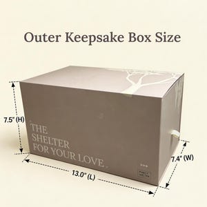May include: A rectangular beige keepsake box with a white tree graphic and the text "THE SHELTER FOR YOUR LOVE" and "PUREST SHELTER". Dimensions are labeled as 13.0 inches long, 7.5 inches high, and 7.4 inches wide with a small pull tab.