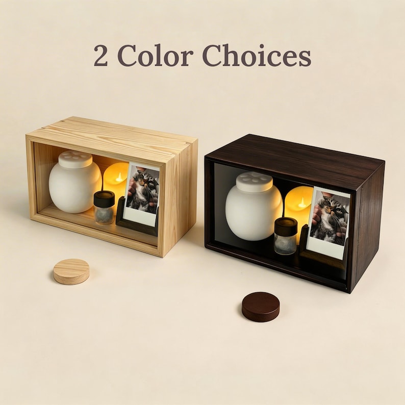 White ceramic pet urn with simple rounded shape and lid, shown as part of a pet memorial keepsake set for holding dog or cat ashes. It has two color choices: oak white and walnut brown