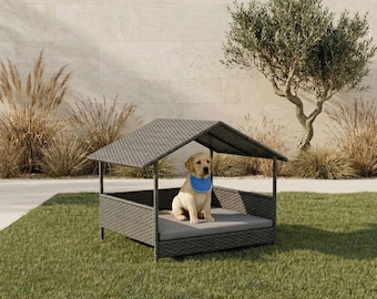 May include: A gray wicker dog house with a peaked roof and a gray cushion. A golden retriever puppy wearing a blue bandana sits inside the dog house on a green lawn.