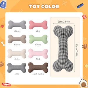 Peut inclure: Divers jouets pour chiens en forme d'os, de diff&eacute;rentes couleurs : noir, rouge, marron, vert, beige, rose, gris et marron fonc&eacute;. Un grand jouet en forme d'os &agrave; carreaux noirs et blancs est &eacute;galement pr&eacute;sent&eacute;, mesurant 20 cm de long et 9 cm de large.
