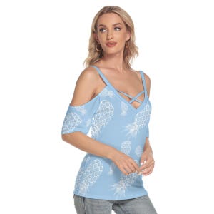 May include: Light blue off-the-shoulder top with a V-neck and white pineapple pattern. The top features spaghetti straps and a crisscross design at the neckline. The sleeves are short, and the fabric appears to be a soft, lightweight material.