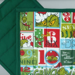 May include: Green quilted pot holder with a colorful print featuring the Grinch, numbers, and the words "How the Grinch Stole Christmas!" by Dr. Seuss.