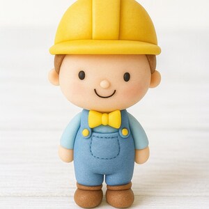 May include: A figurine of a construction worker wearing a yellow hard hat, blue overalls, and a yellow bow tie. The figure has a smiling face and brown shoes. The overall design is cartoonish and friendly.