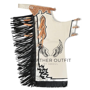 May include: Cream-colored leather chaps with black fringe and decorative stitching. Features a belt, wing design, and the text "LEATHER OUTFIT BY ABDUL". The chaps have silver accents and leather straps.