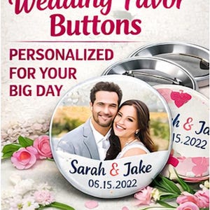 May include: Wedding favour buttons featuring a photograph of a smiling couple, personalised with the names "Sarah & Jake" and the date "06.15.2022". The buttons are white with a metal backing, surrounded by pink and white flowers.