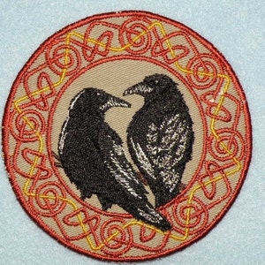 May include: Embroidered patch with two black ravens in a red and yellow Celtic knot design.