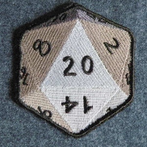 May include: A brown and white embroidered patch shaped like a twenty-sided die with the number "20" in the center.