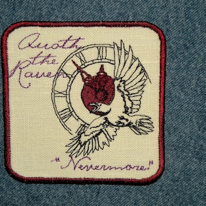 May include: A white embroidered patch with a red border. The patch features a black and white illustration of a bird flying with a clock behind it. The text "Awoth the Raven" and "Nevermore" are embroidered in purple.
