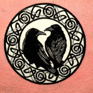 May include: Black embroidered patch with two ravens facing each other in a heart shape, surrounded by a silver Celtic knot design.