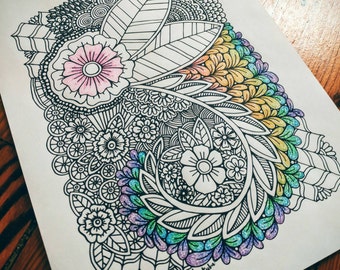 May include: A black and white intricate mandala design with a pink flower in the center. The mandala is surrounded by a rainbow of colors, including yellow, orange, red, purple, blue, and green.
