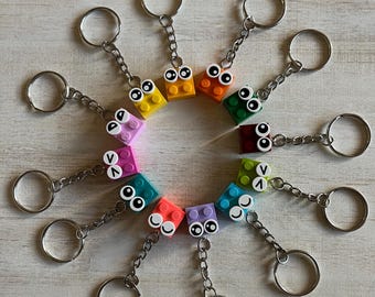18 Pack Authentic 2x2 Brick Keychain Classroom Valentines | Party Favors | Birthday Favors with Assortment of Eyes