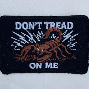 May include: Black embroidered patch with a scorpion and the text "Don't Tread On Me".