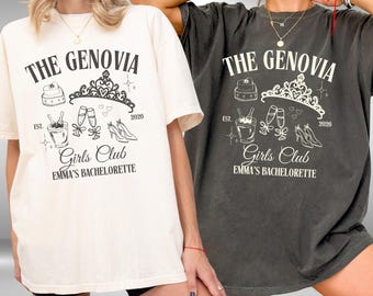 May include: Two t-shirts, one ivory and one pepper, feature the text "THE GENOVIA Girls Club EMMA'S BACHELORETTE" with a tiara, cake, champagne, and heels graphic. The year "2026" is also included in the design.