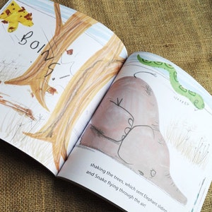 May include: An open children's book with illustrations of a brown elephant sliding down a tree trunk and a green snake flying through the air. The text reads "BOING! shaking the trees, which sent Elephant sliding, and Snake flying through the air!"