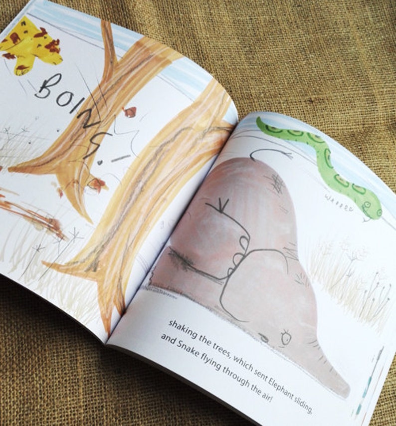 May include: An open children's book with illustrations of a brown elephant sliding down a tree trunk and a green snake flying through the air. The text reads "BOING! shaking the trees, which sent Elephant sliding, and Snake flying through the air!"