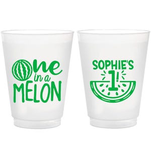 May include: Two white plastic cups with green watermelon designs. One cup says "one in a melon" and the other says "Sophie's 1!"