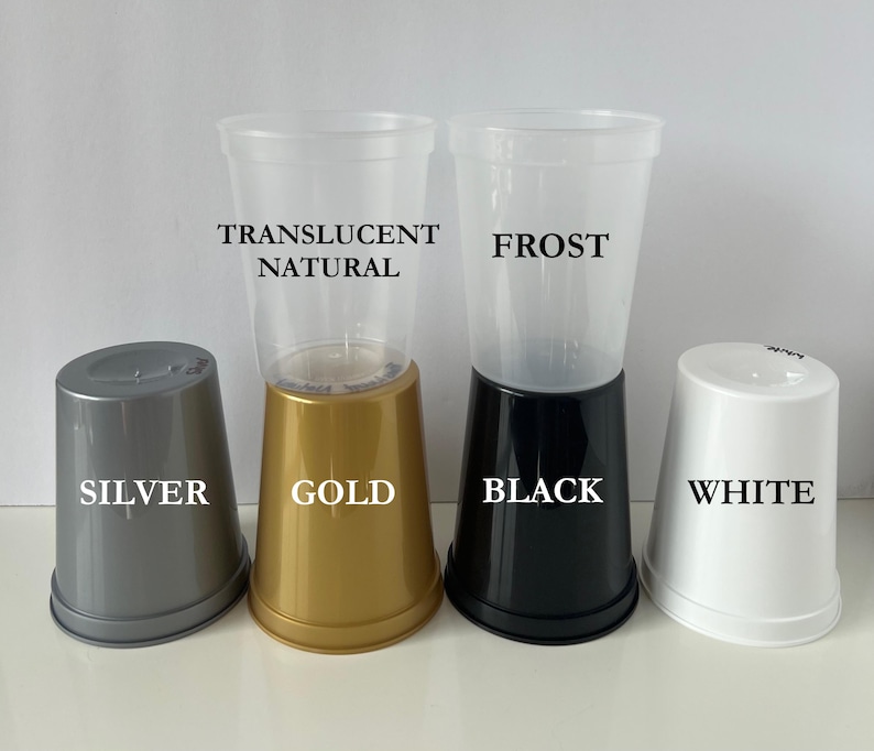 May include: Four plastic cups with different colored bases. The cups are labeled "Translucent Natural", "Frost", "Silver", and "White". The bases are labeled "Gold", "Black", "Silver", and "White".
