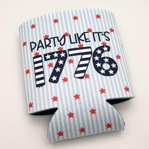 May include: A beverage insulator featuring a light blue and white vertical striped pattern with small red stars scattered throughout. The text PARTY LIKE IT'S 1776 is printed in dark blue, with the numbers styled in stripes and star patterns.