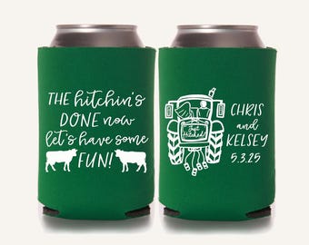May include: Two green can coolers with white text and graphics. One cooler says "THE hitchin's DONE now let's have some FUN!" with cow silhouettes. The other cooler has a tractor graphic and says "CHRIS and KELSEY 5.3.25".