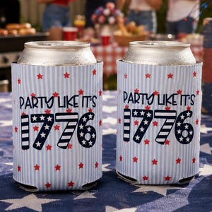 May include: Two cylindrical foam can coolers featuring a light blue and white vertical striped pattern with small red stars. The text "PARTY LIKE IT'S 1776" is printed in dark blue, with the numbers "1776" styled in patriotic stripes and stars.