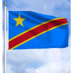 May include: A blue flag of the Democratic Republic of the Congo, with a large yellow star in the upper left corner and a red diagonal stripe edged in yellow. The flag is waving in the wind against a cloudy sky.