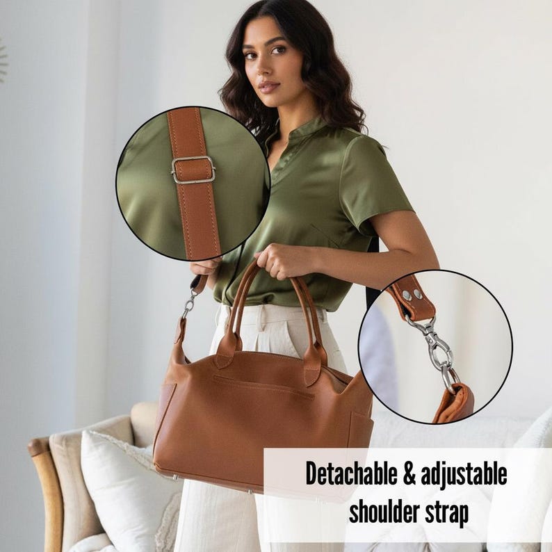 May include: A tan handbag featuring a smooth finish, two top handles, and a detachable, adjustable shoulder strap. Two circular insets highlight the silver-toned metal hardware, including the strap buckle and the swivel clasp attachment mechanism.