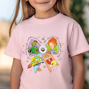 May include: A light pink t-shirt featuring a colorful graphic of cartoon characters and the text "Make wishes get messy". The shirt has short sleeves and a crew neck. The Threadventure Apparel logo is visible.
