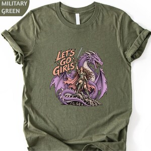 A green t-shirt with a graphic design depicting a woman riding a dragon.