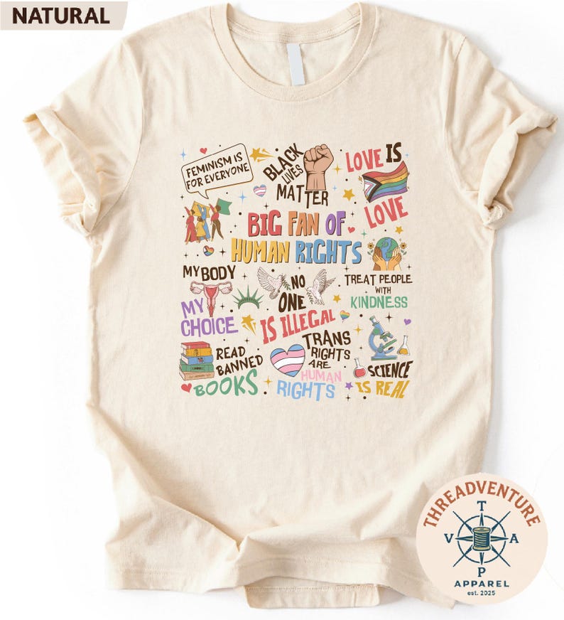 The image is a t-shirt with a collage of various colorful and diverse messages related to human rights, gender equality, and social justice.