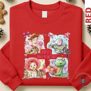 A red long-sleeved shirt with a colorful graphic design featuring characters from the Toy Story movie, including Woody, Buzz Lightyear, and a dinosaur.