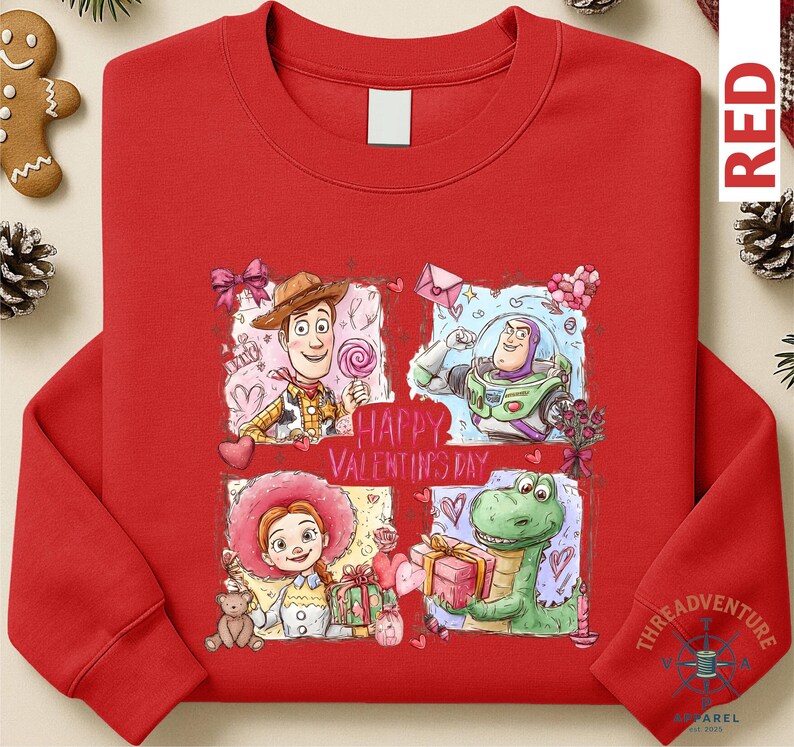 A red long-sleeved shirt with a colorful graphic design featuring characters from the Toy Story movie, including Woody, Buzz Lightyear, and a dinosaur.